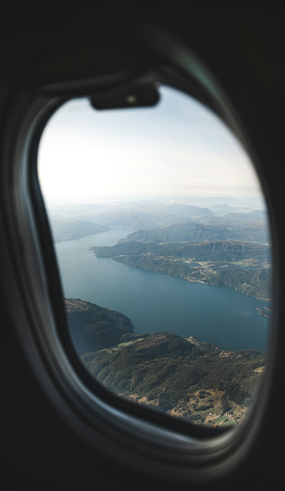 aerial view of green mountains and river during daytime