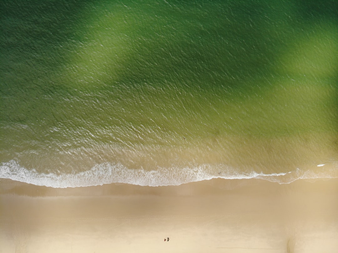 person surfing on sea waves during daytime