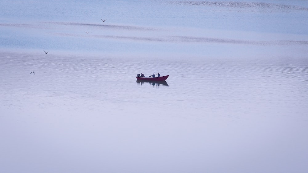 man riding on boat on body of water during daytime