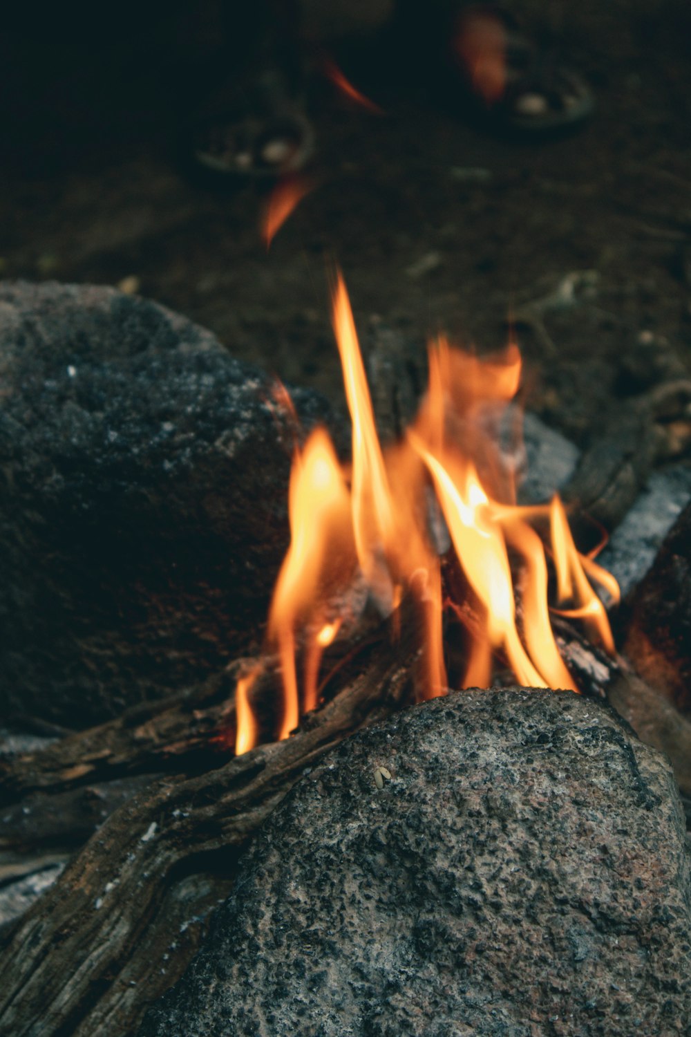 fire on gray rock during daytime