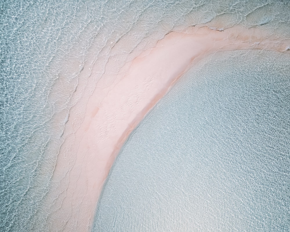 white and pink textile with water