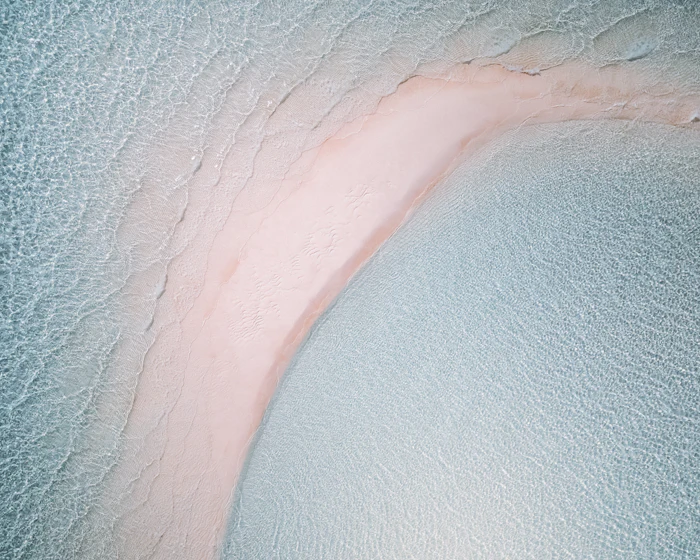 Pink-tinted sandbar at low tide in the Exuma Cays, Bahamas