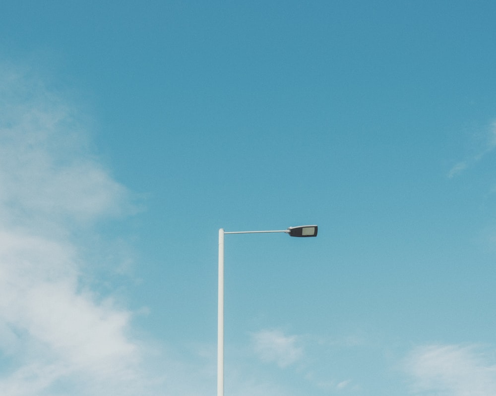 white street light under blue sky during daytime