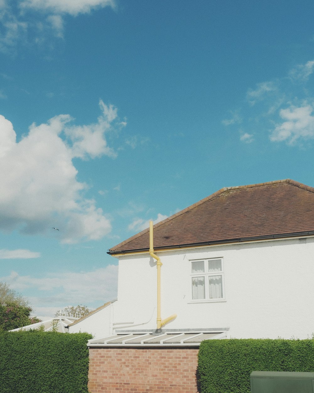 white and brown house under blue sky during daytime