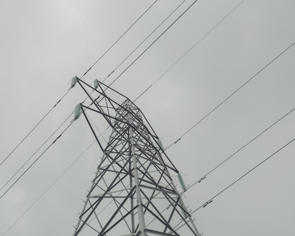 black electric tower under gray sky