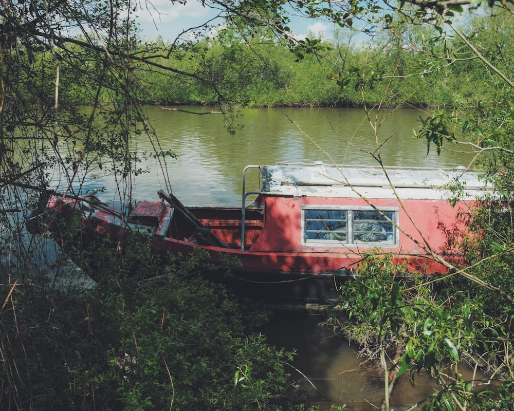 red and white boat on river during daytime
