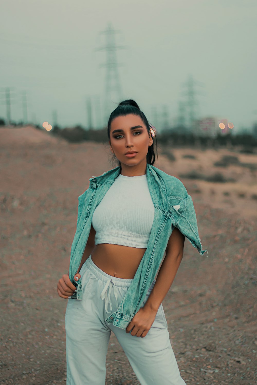 woman in blue denim jacket and white crop top