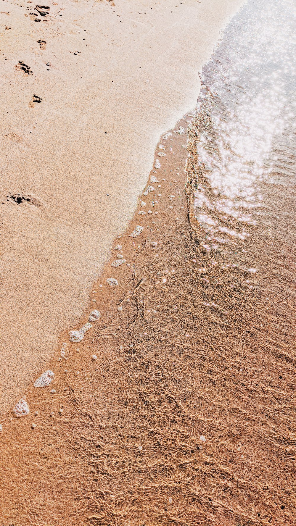 brown sand with footprints during daytime