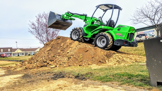 A loader moving dirt at a landscaping project.