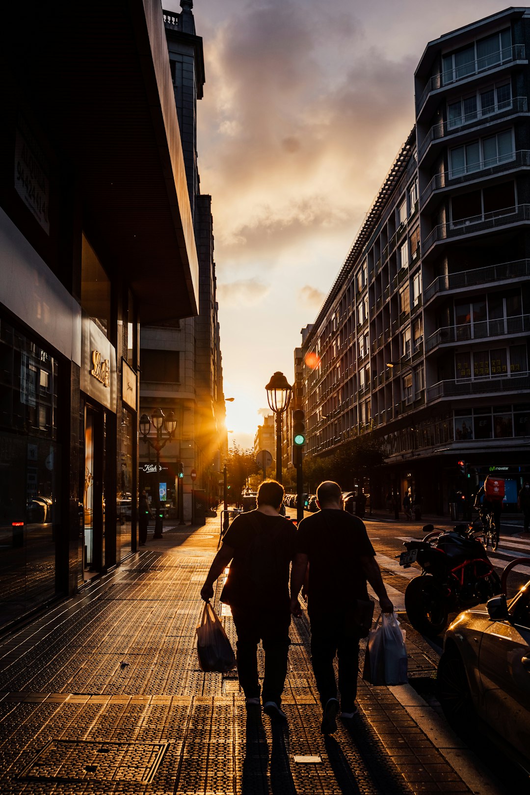 people walking on sidewalk near buildings during daytime