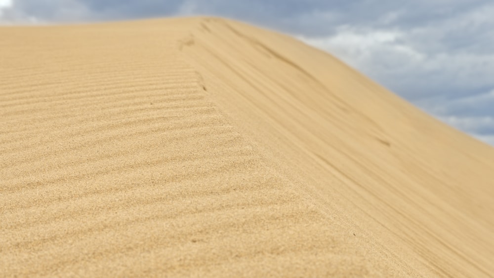 brown sand under blue sky during daytime