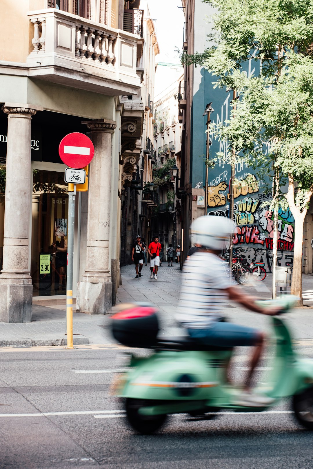 man in white shirt riding blue motorcycle on road during daytime