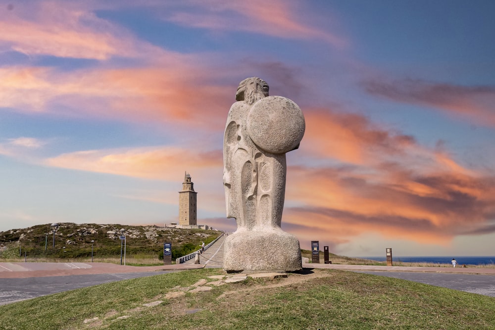 gray concrete statue under cloudy sky during daytime