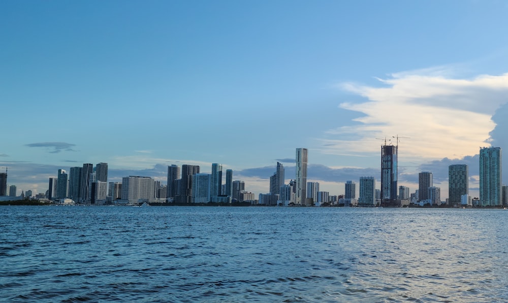 city skyline across body of water during daytime