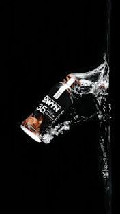 a bottle of soda in the dark water