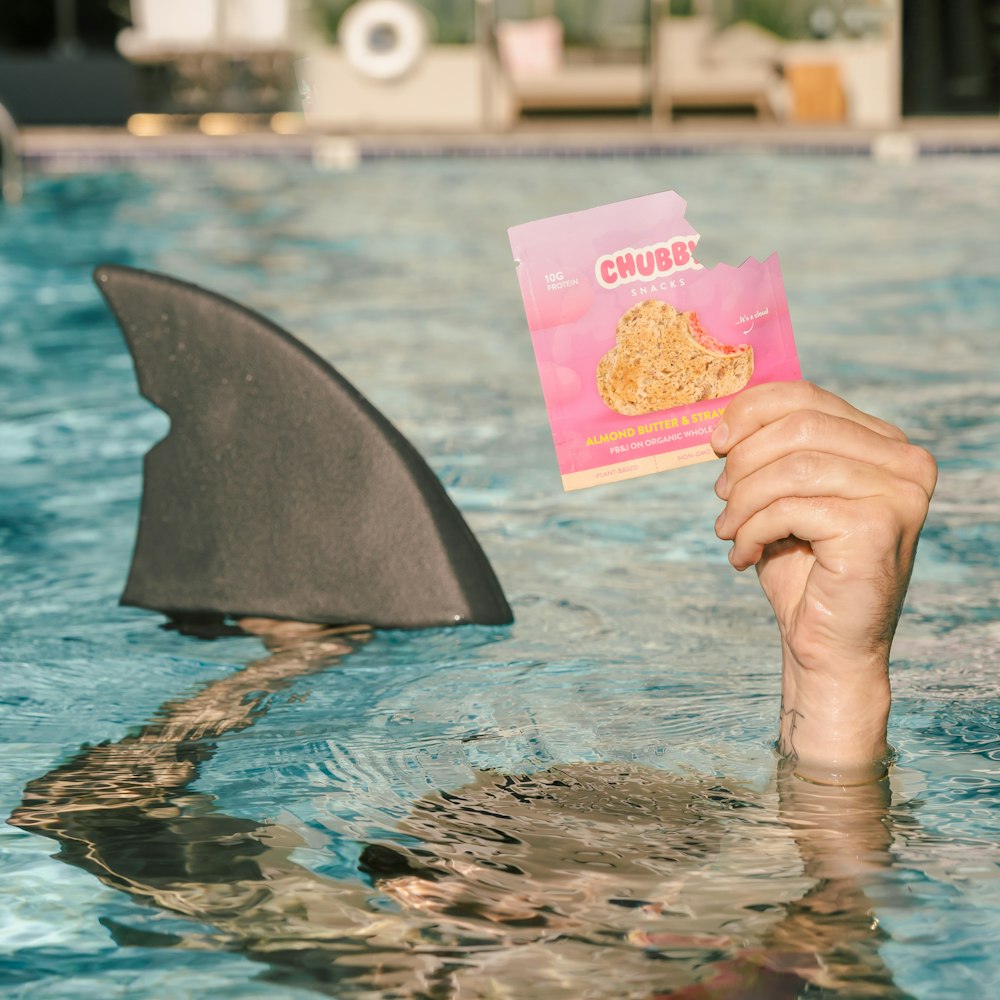 person holding pink and yellow floral card