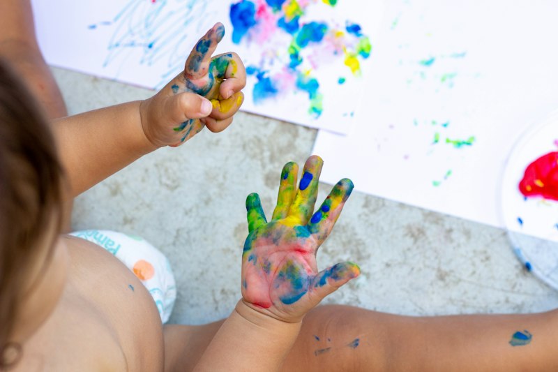 Little hands covered in paint
