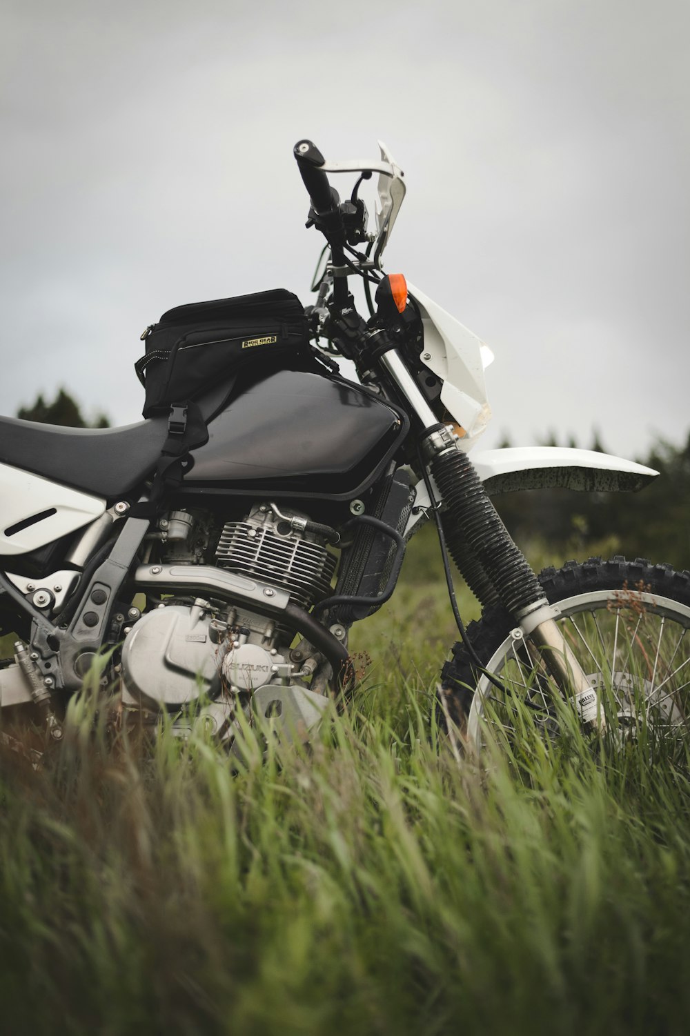 black and white motorcycle on green grass field