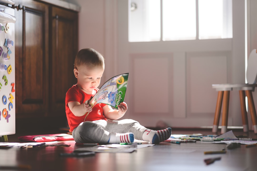 boy in red long sleeve shirt reading book