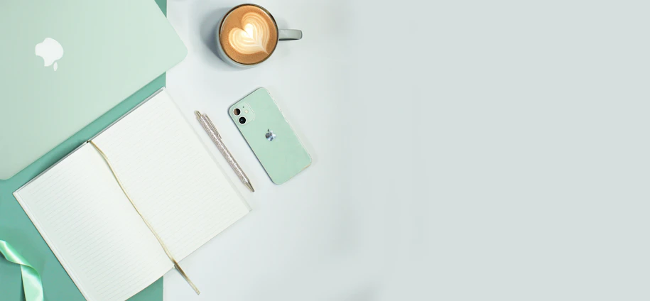 A sleek digital planner open on a tablet with navy blue and gold accents, surrounded by a coffee cup and notebook.