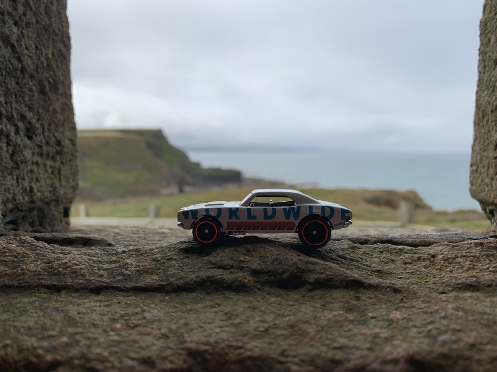 red and white car on brown soil