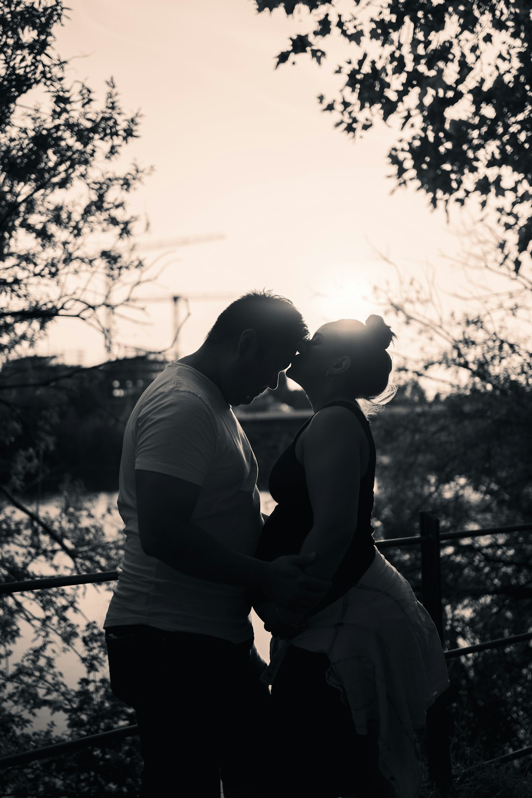 man and woman kissing during sunset