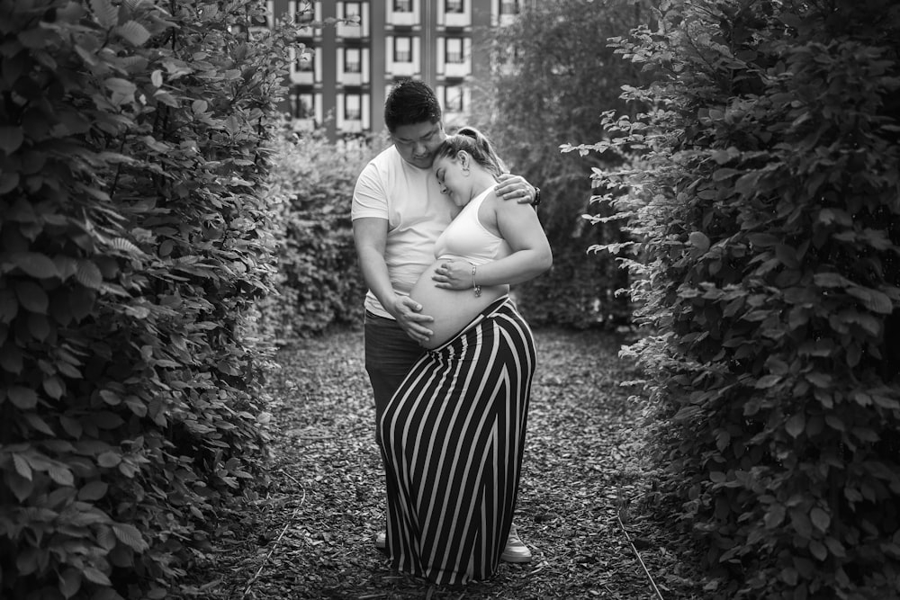 man and woman kissing in grayscale photography