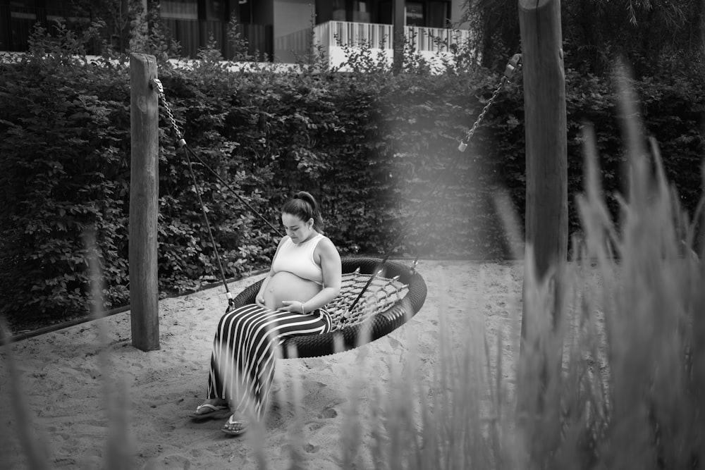 woman in black and white striped dress sitting on chair