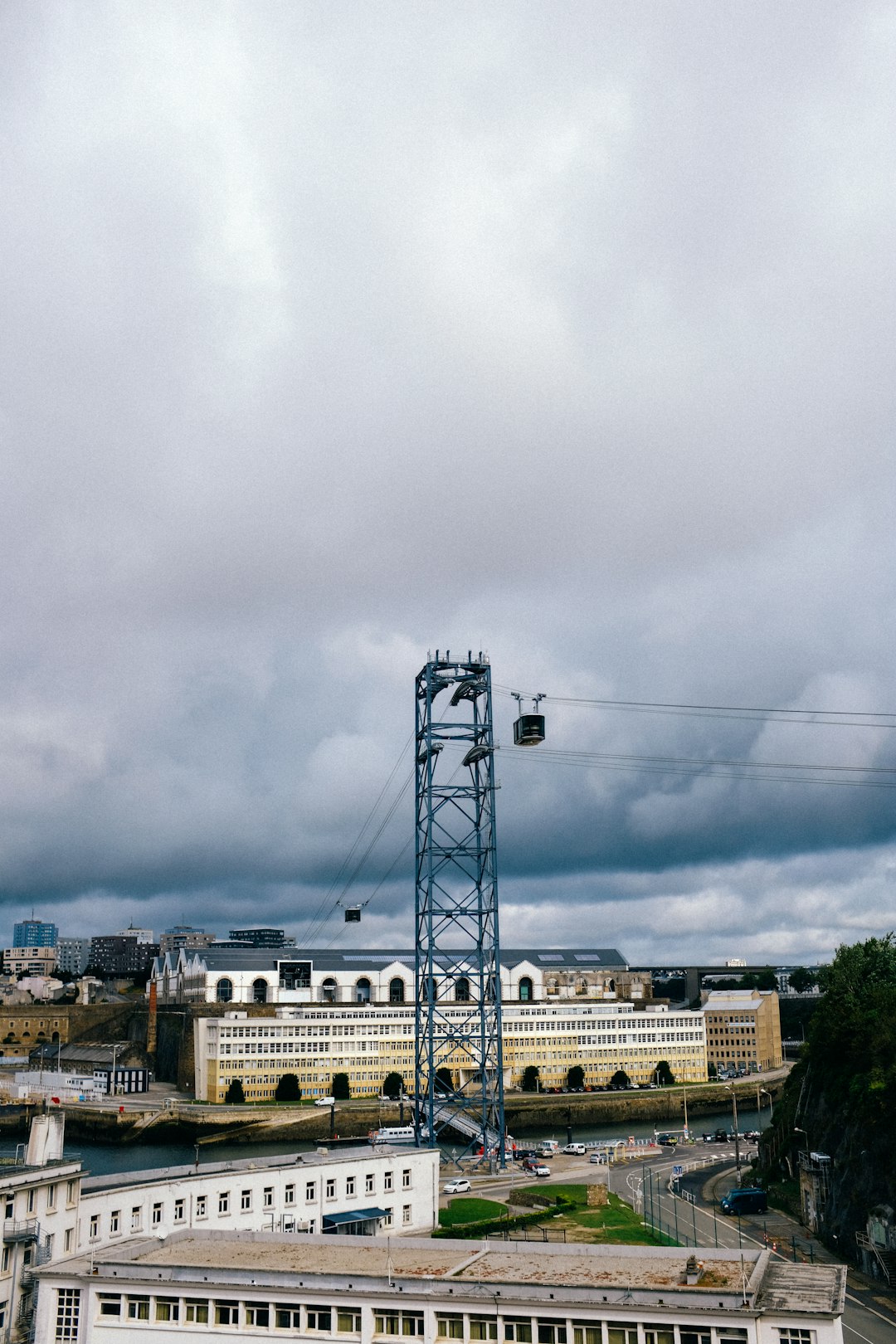 white concrete building under white clouds during daytime