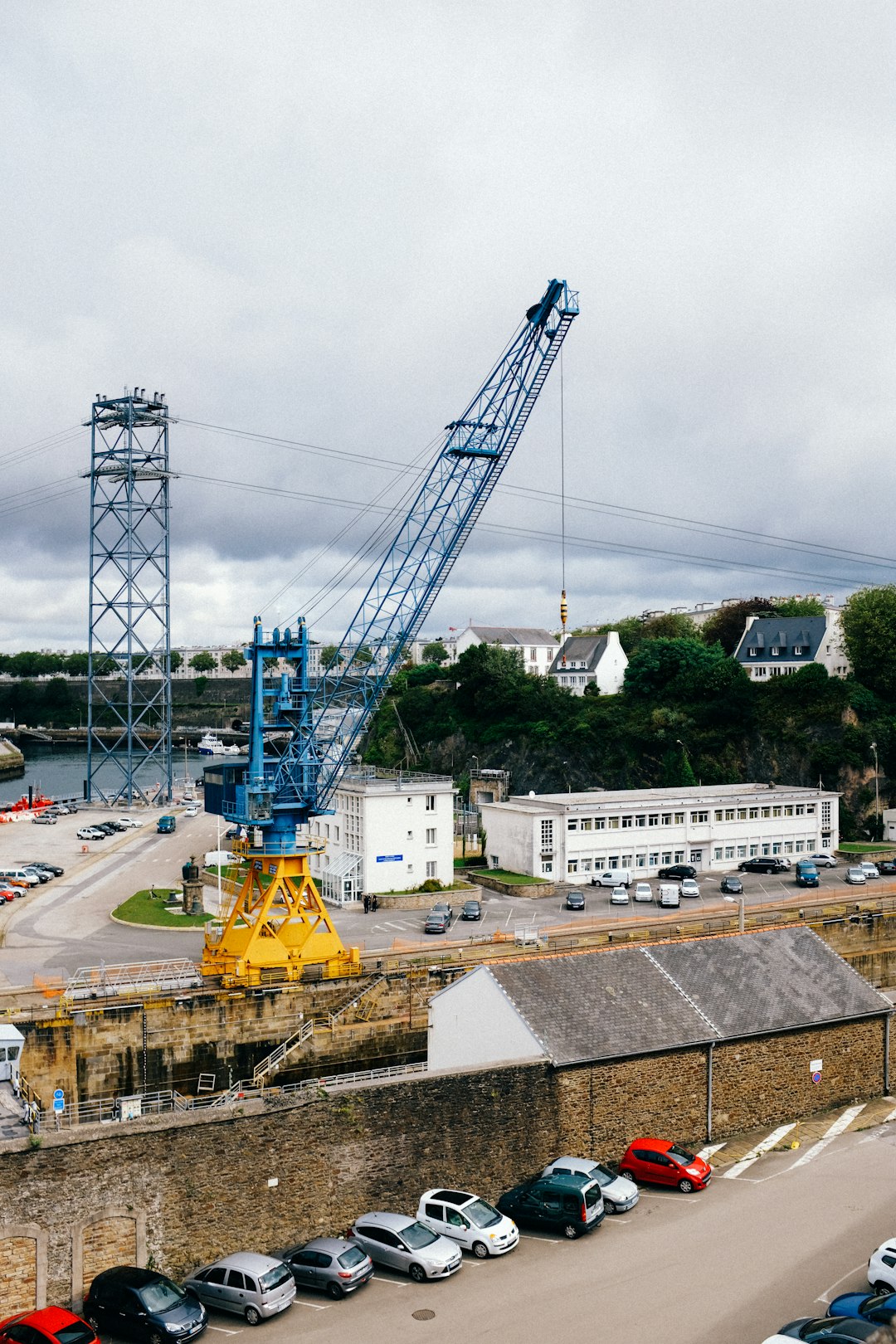 yellow crane near white building during daytime