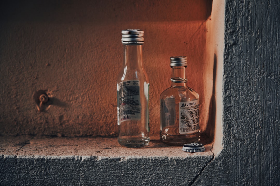 2 bottles on gray concrete floor