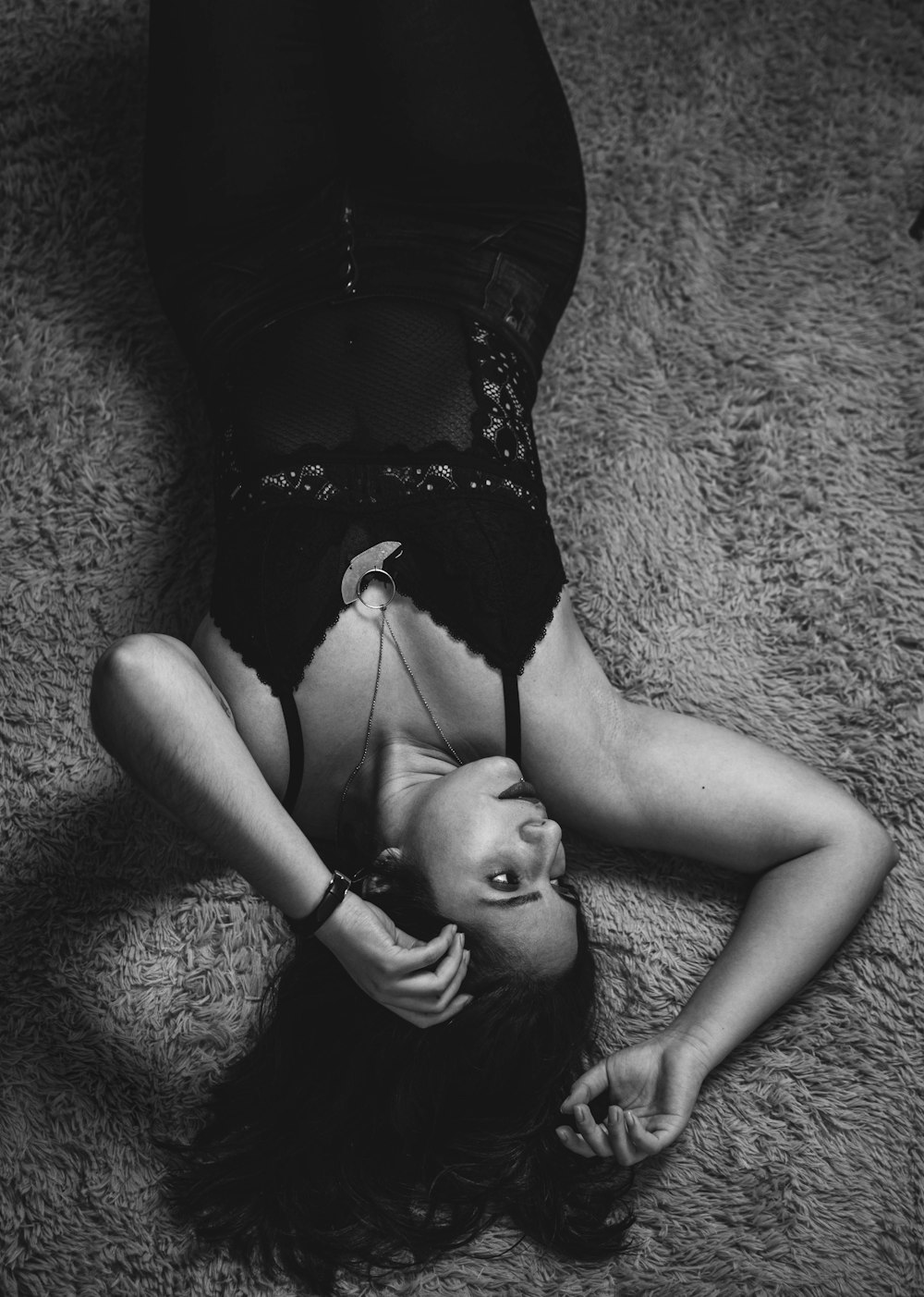 woman in black tank top lying on the floor