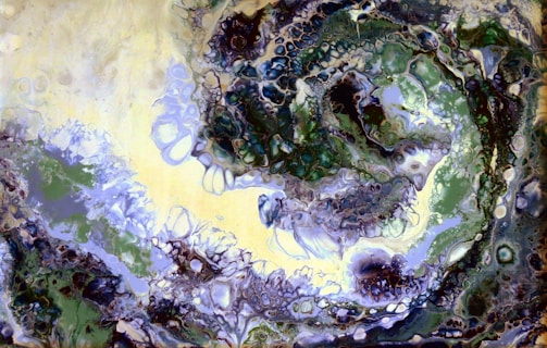 Abstract swirling forms in deep neutral tones, suggesting emerging patterns.