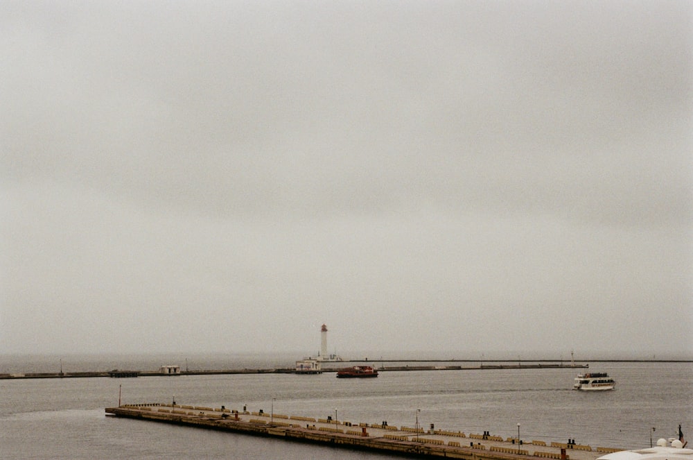 white ship on sea under white sky during daytime