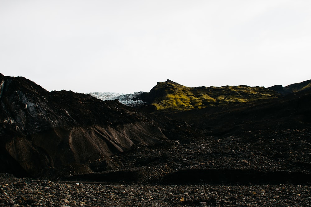 brown rocky mountain under white sky during daytime