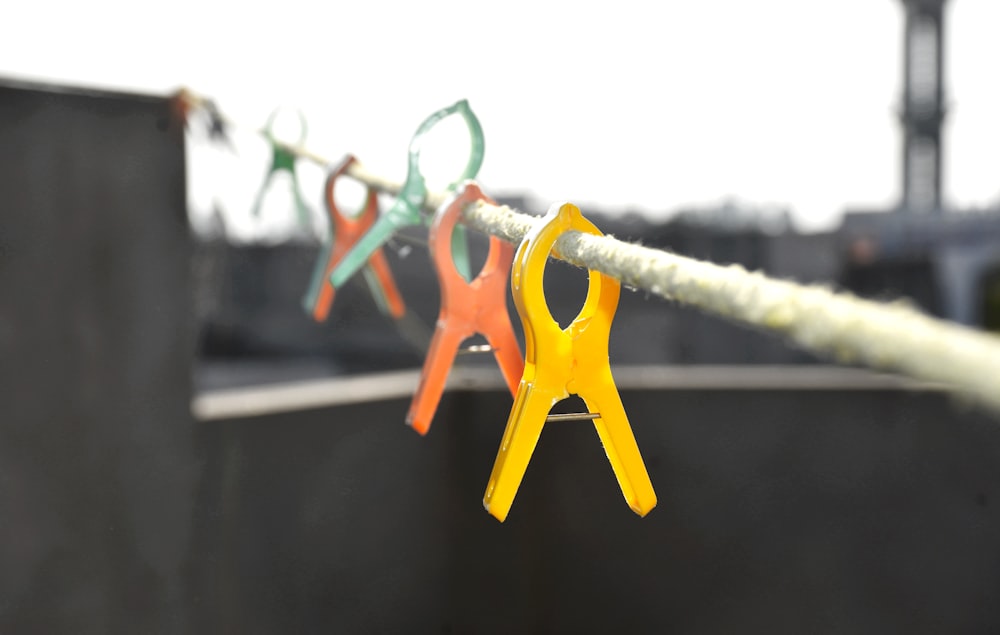 orange clothes pin on gray metal wire