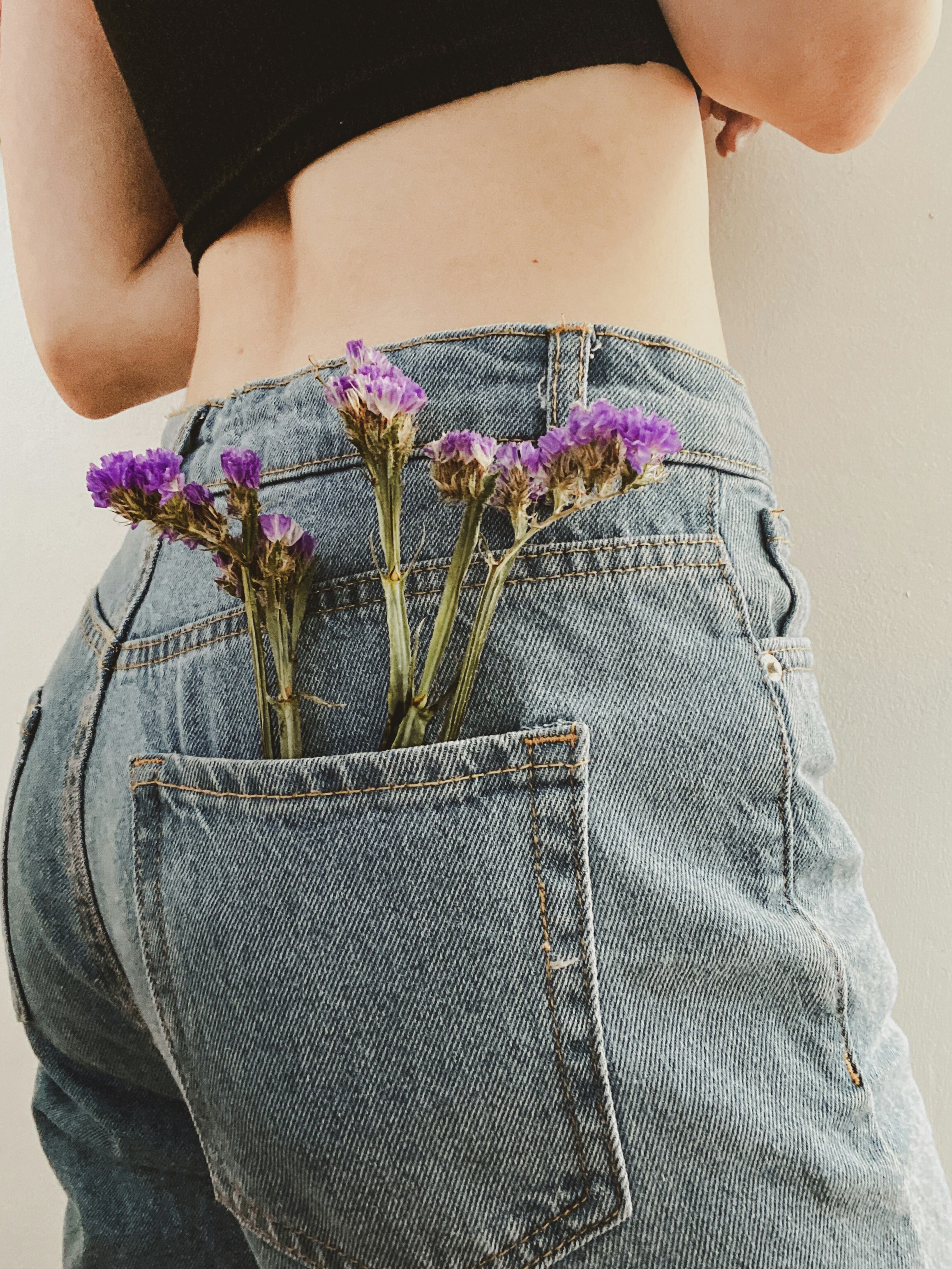 Image of a girl with flowers in her back pocket
