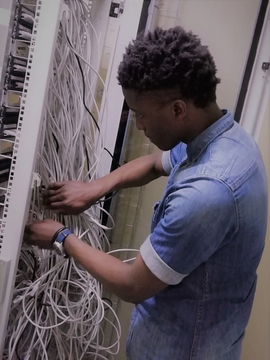 A technician neatly connecting network cabling