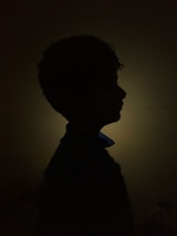 Soft pastel background with a subtle silhouette of a calm face in meditation.