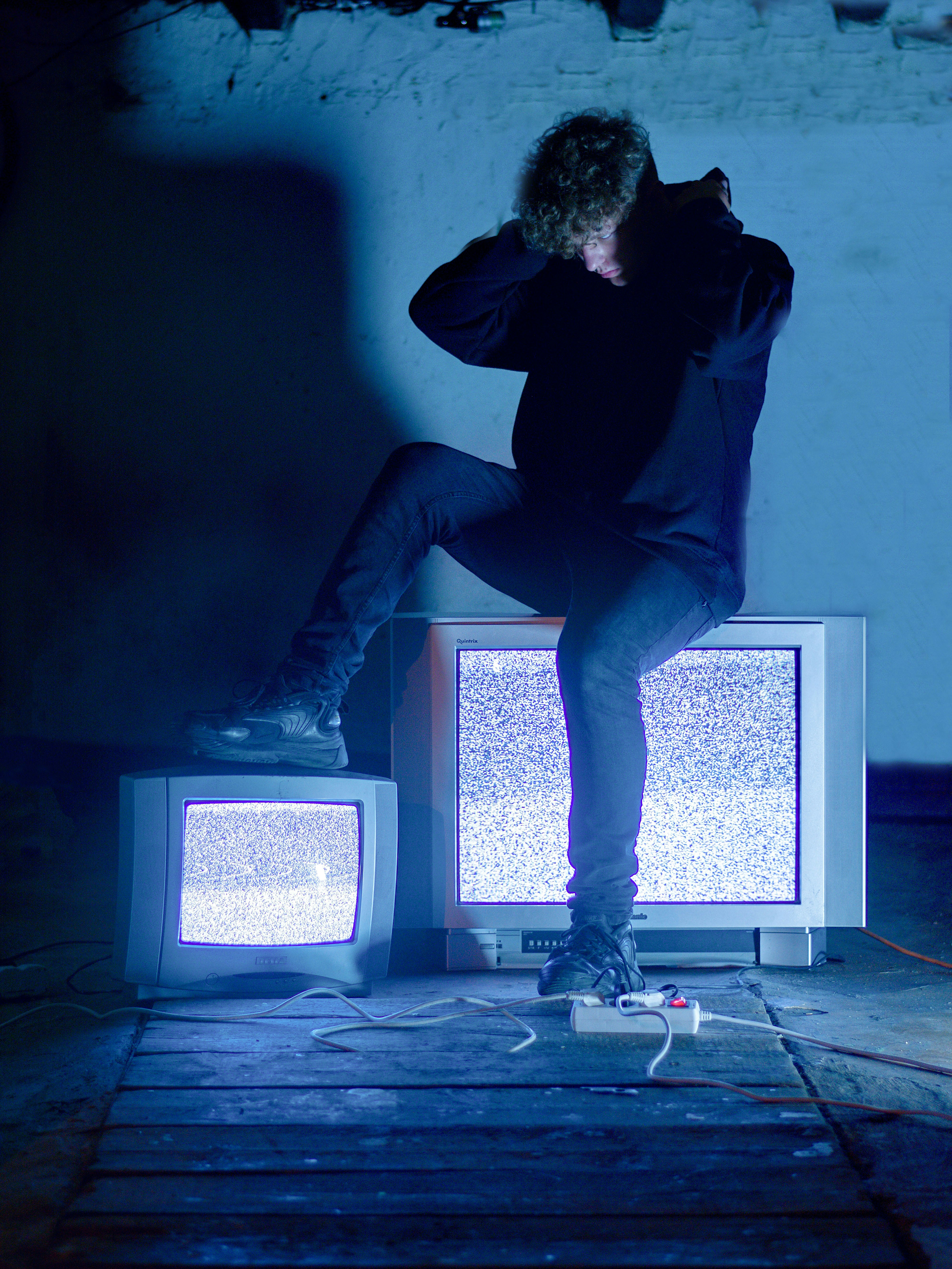 Guy (me lol) sitting on an old CRT TV in dark room