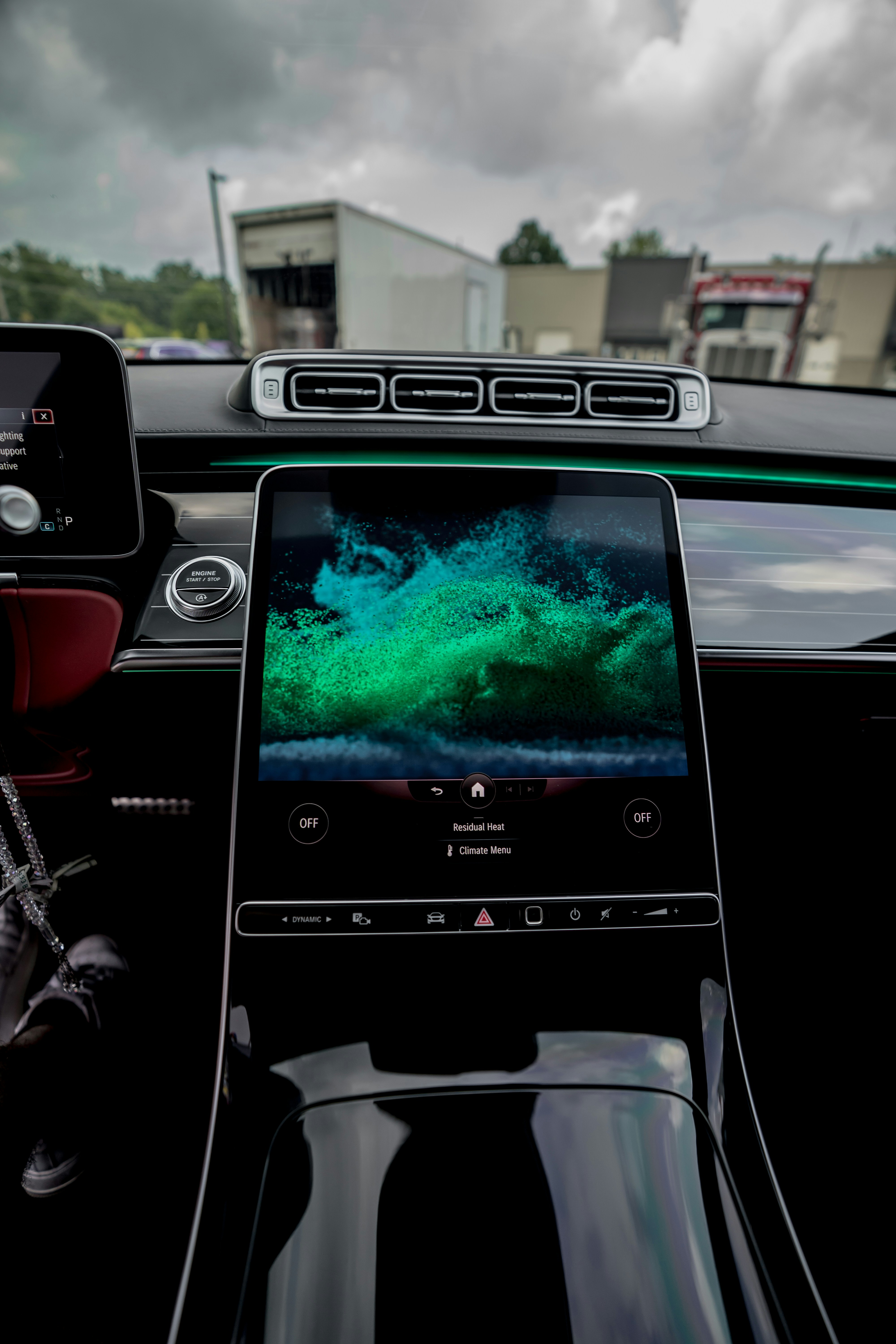 person holding iphone 6 taking photo of car