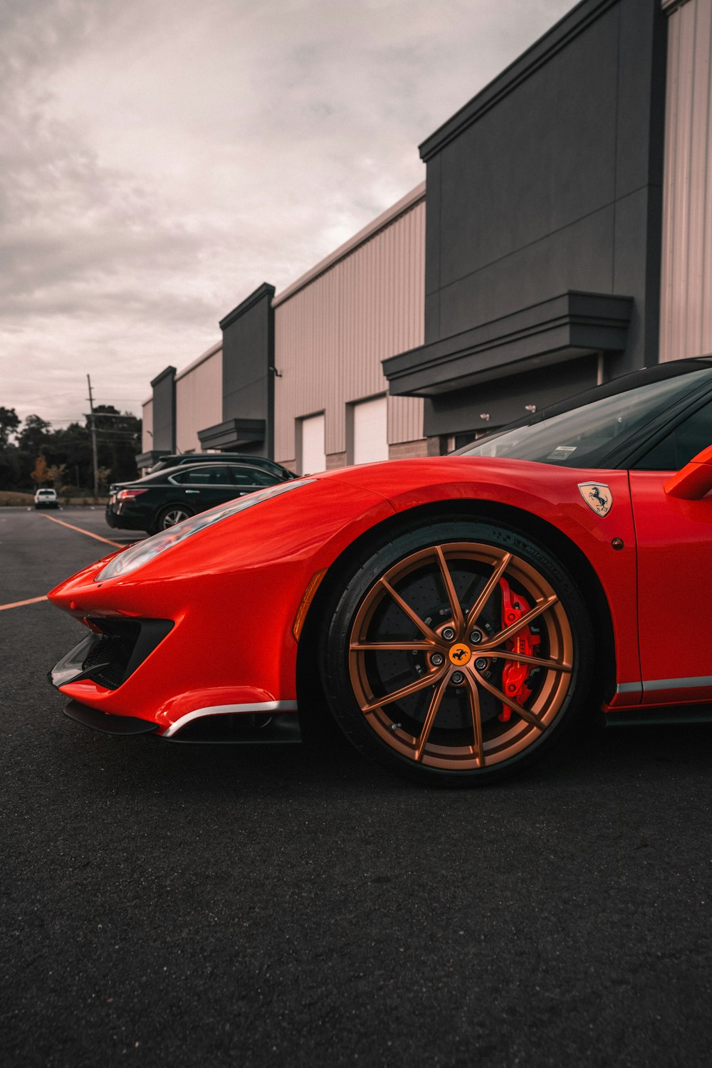 red ferrari 458 italia parked in front of building