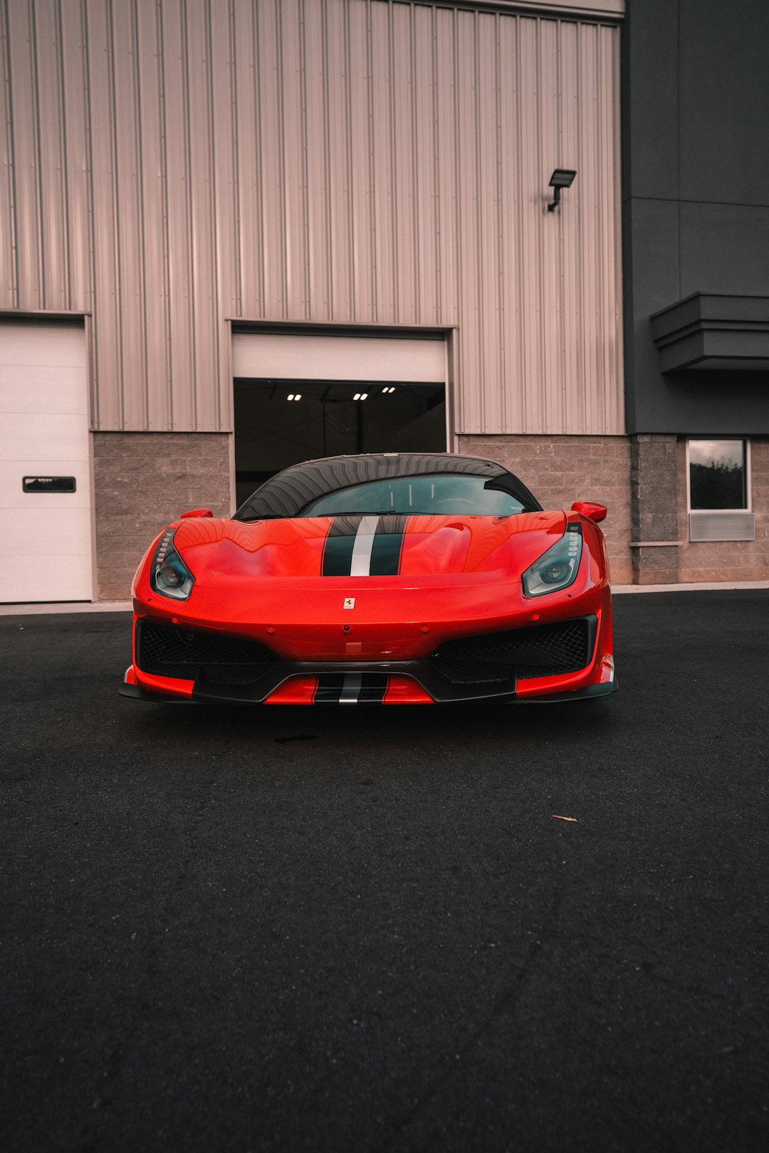 red ferrari 458 italia parked in garage