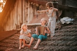 a group of children sitting on top of a roof