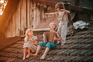 a group of children sitting on top of a roof