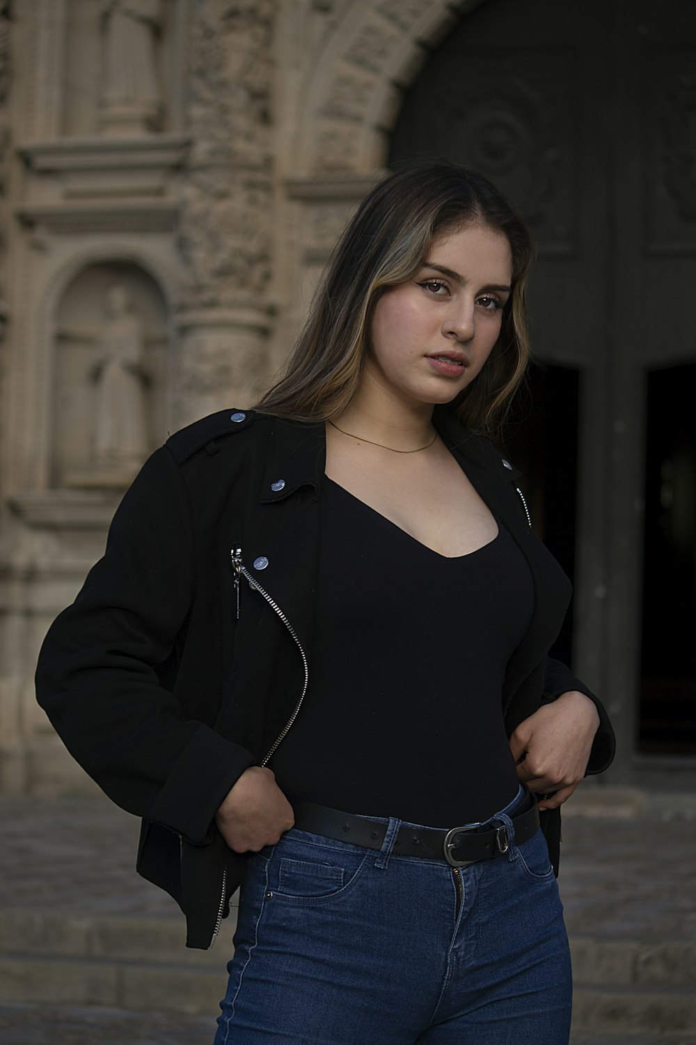 woman in black long sleeve shirt and blue denim jeans