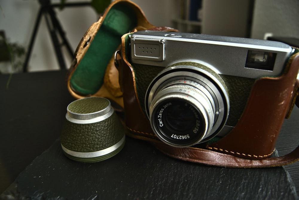 black and silver camera on black leather textile