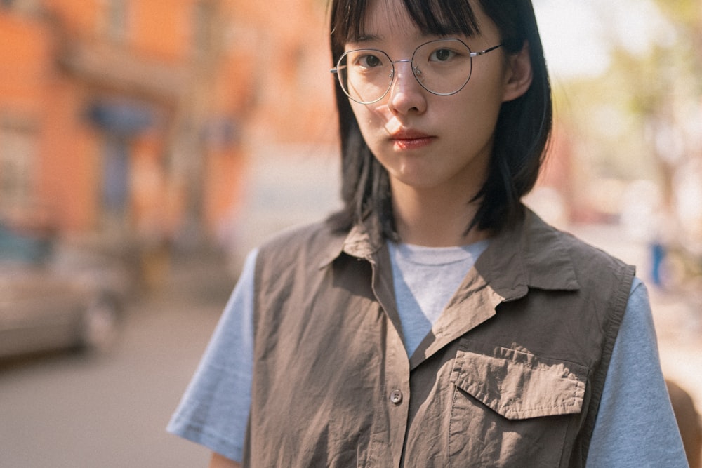 woman in gray button up shirt wearing black framed eyeglasses