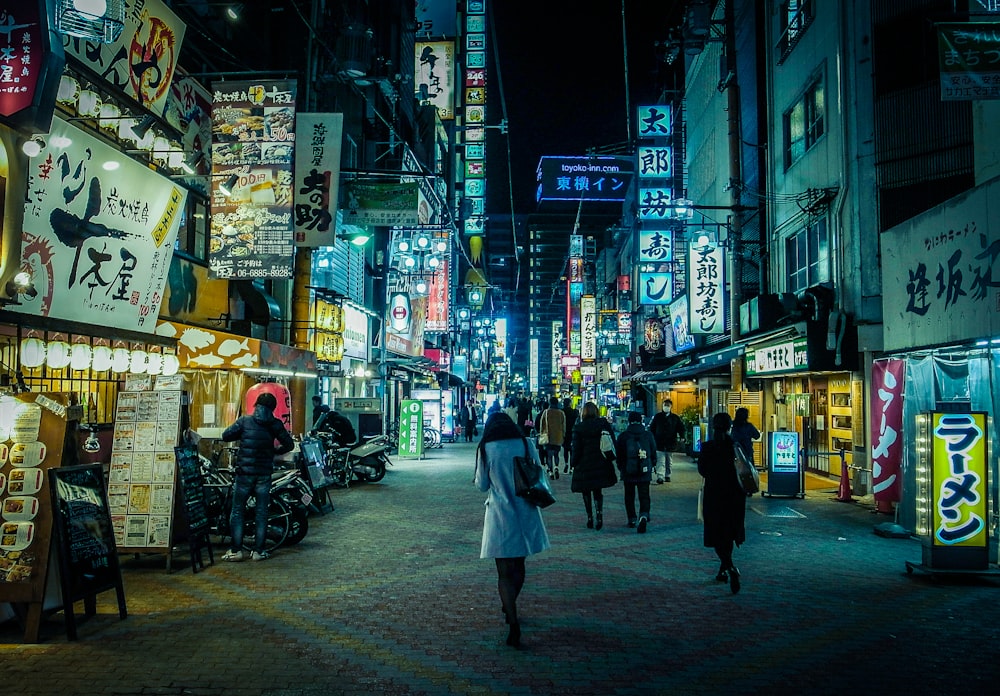 people walking on street during night time