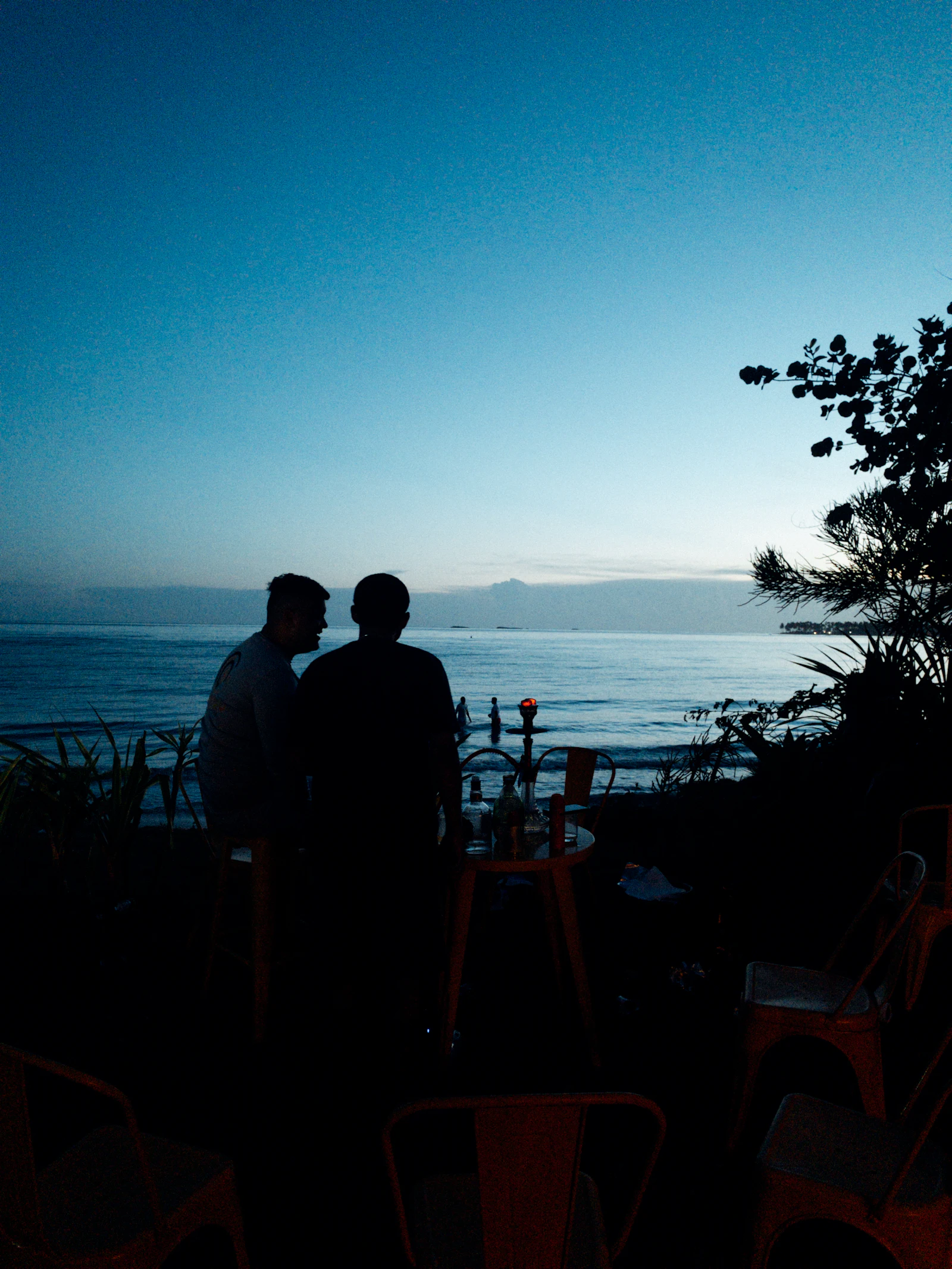 People on the street at the edge of town